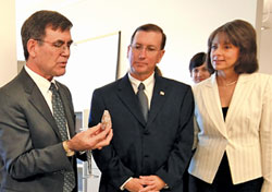 Torrey Pines President Richard Houghten (left) shows Florida Senator Ken Pruitt and his wife Aileen a shellfish specimen that secretes compounds scientists are now using in the laboratory to develop treatments for pain.