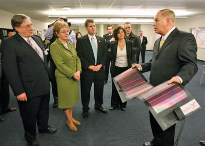 Ohio Gov. Ted Strickland (right) looks at a thin-film solar product made at Xunlight with (from left) University of Toledo President Dr. Lloyd Jacobs, U.S. Congress Representative Marcy Kaptur, State of Ohio Representative Matt Szollosi and University of Toledo Incubation Director Megan Reichert-Kral.
